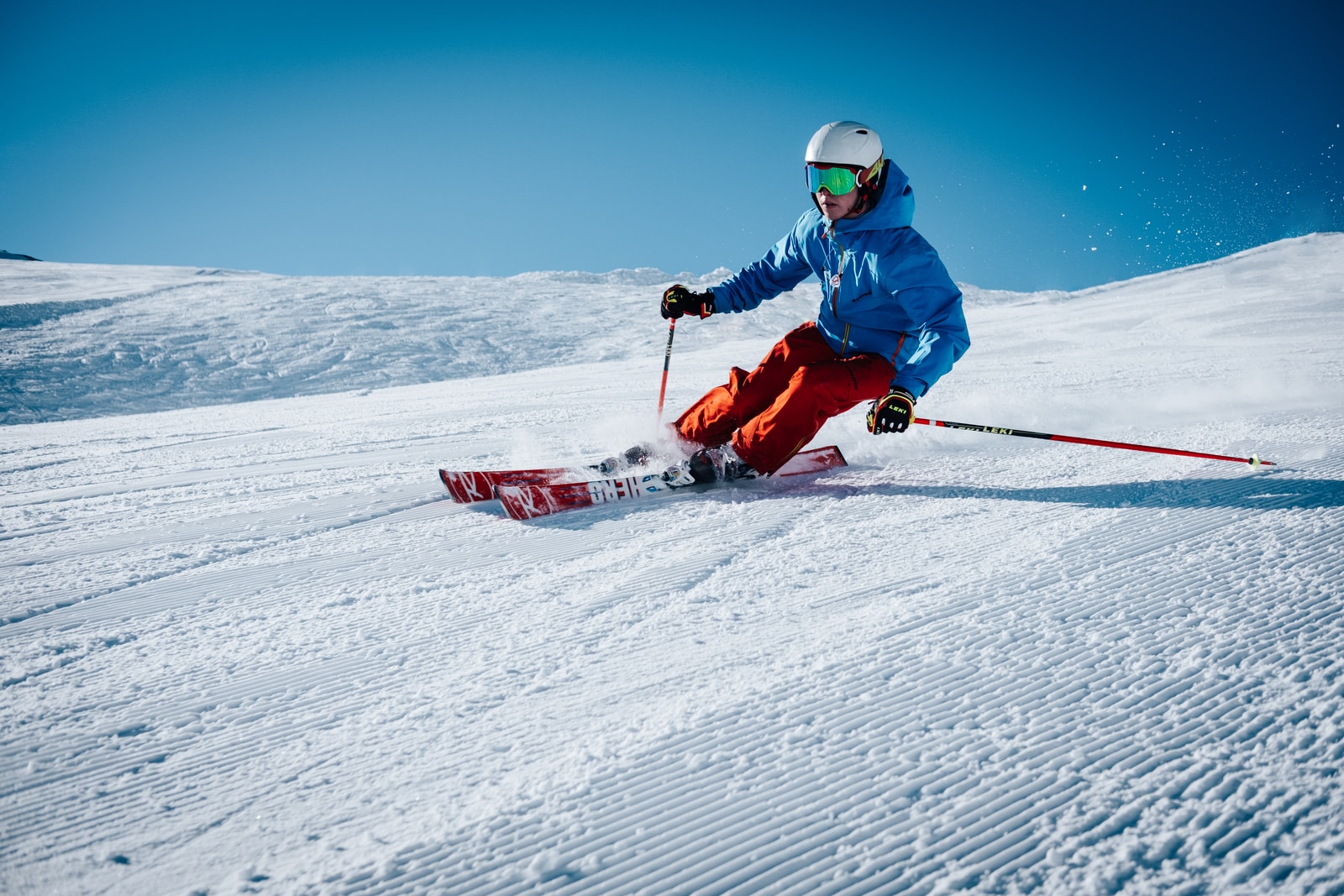 man ice skiing on hill