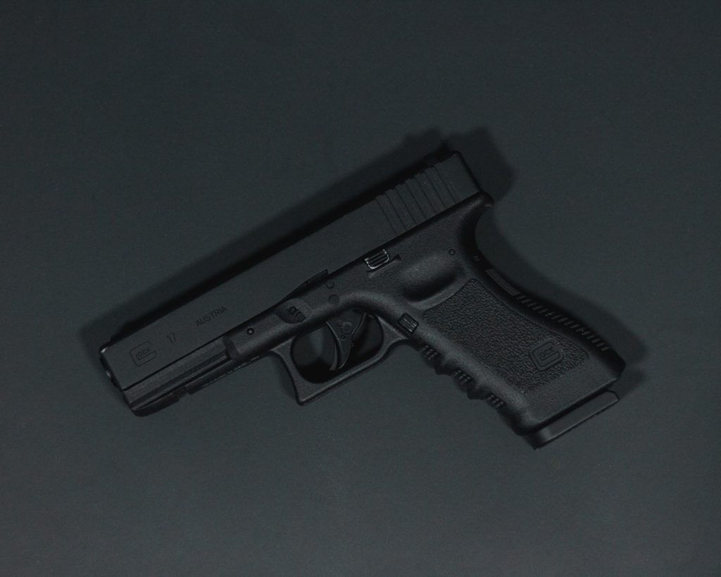 black semi automatic pistol on gray surface