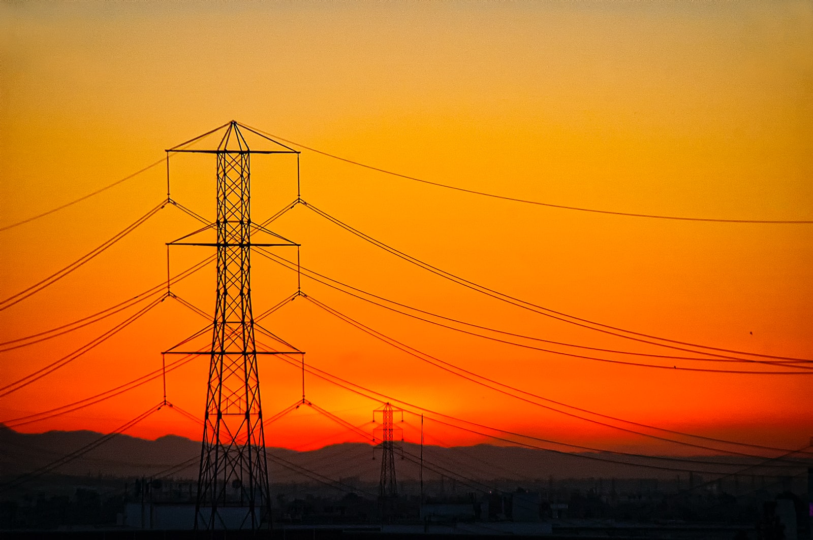 transmission towers during golden hour