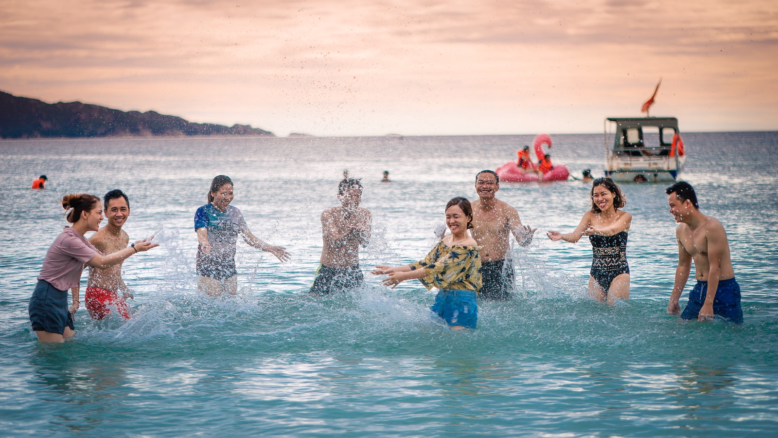 people splashing body of water on sea